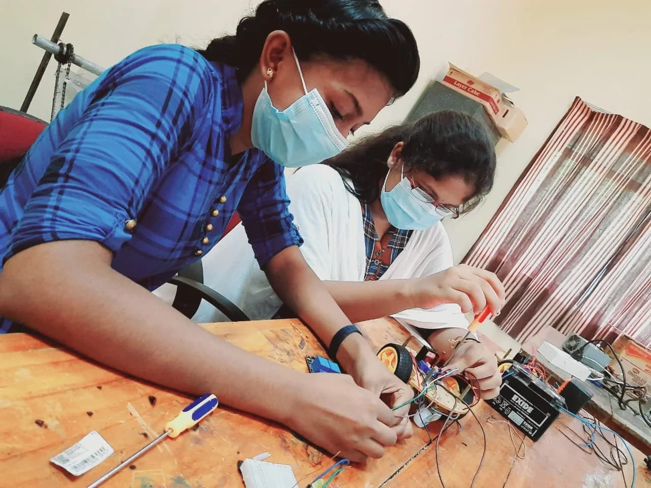 Two people working together with electronic equipment